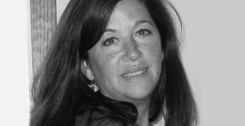 Photograph of a woman with tan skin and long dark hair.