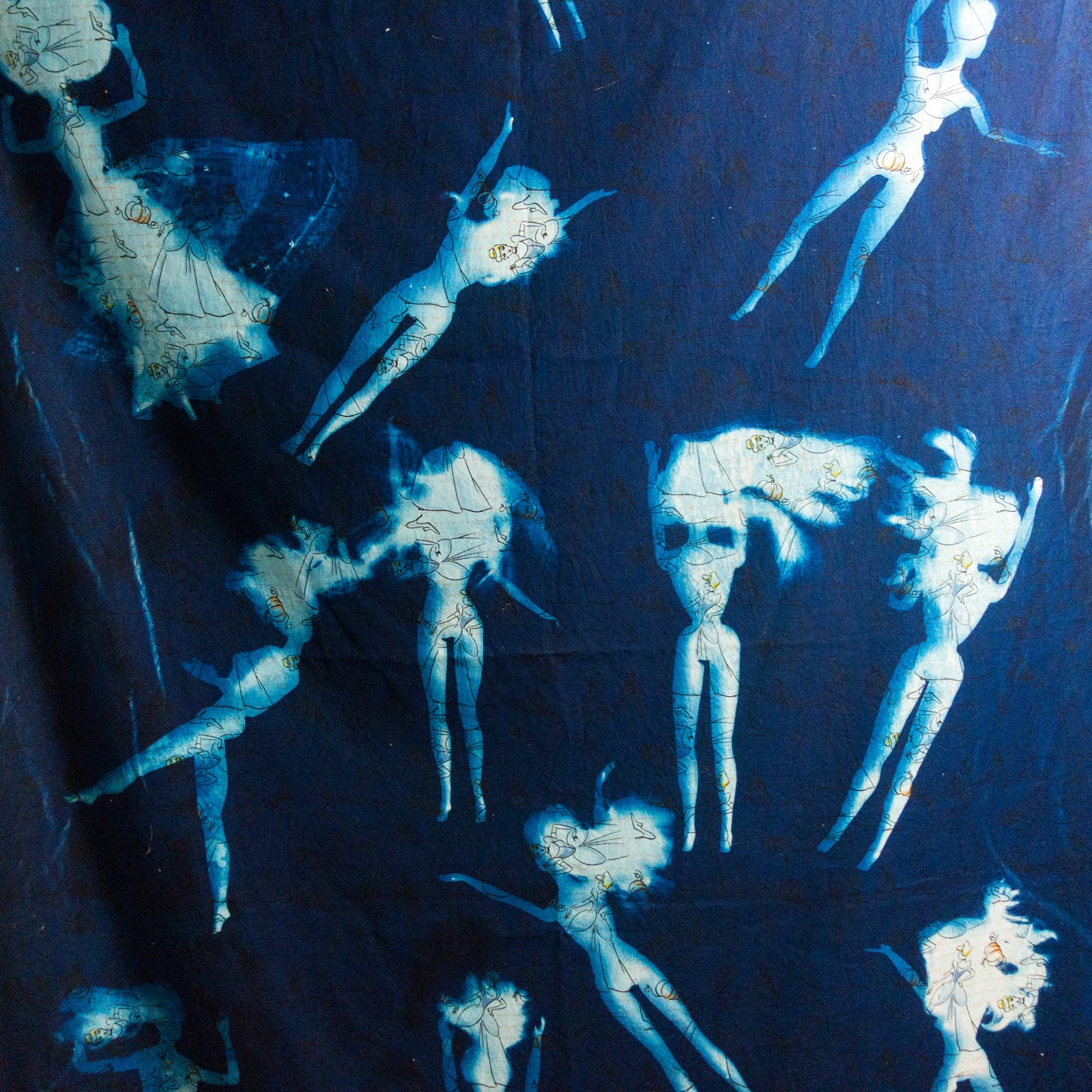 Blue fabric with bleached Barbie Doll figures in various falling poses.