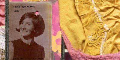 Photograph collage with a framed black and white photo of a woman with a bob haircut that has a bullet hole near the center right. To the right of this is fabric in pink and yellow with a yellow lace running down the center.