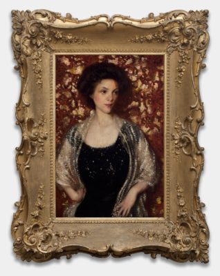 Painting of a woman in a very wide, ornate gold frame. The woman is standing in front of a red and gold background. She has pale skin, hair piled up on her head, and is wearing a glittering black dress with a transparent gold shawl around her shoulders.