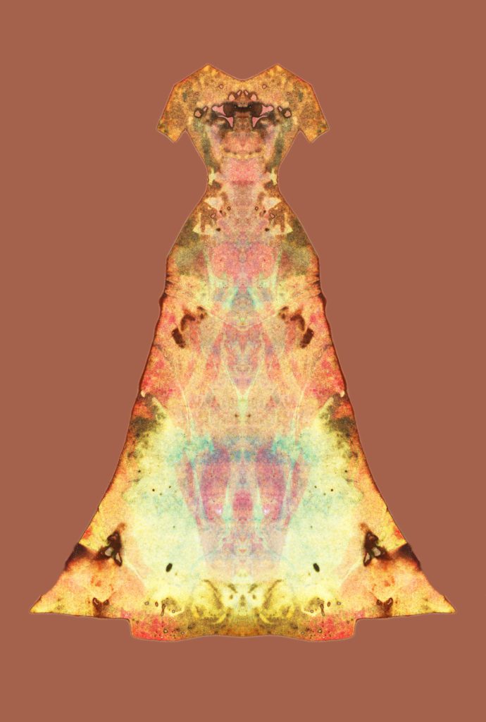 Photograph with a sold rusty orange background an a dress form with short sleeves and a wide A-line skirt in a kaleidoscope pattern of bright yellow and peach-orange.