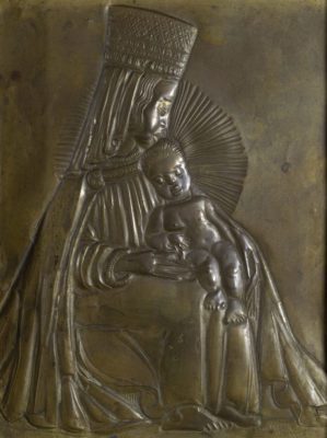 Flat metal sculpture of a woman in a tall square hat and robes, seated holding a nude baby with a hale behind him.