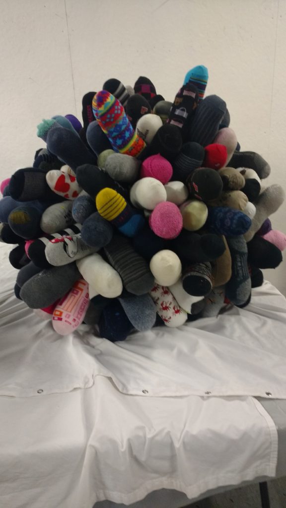 Photograph of a large sculpture ball made of stuffed socks.