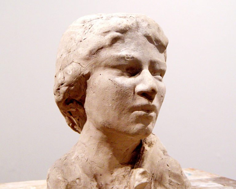 Bisque portrait bust of a young woman with short hair.