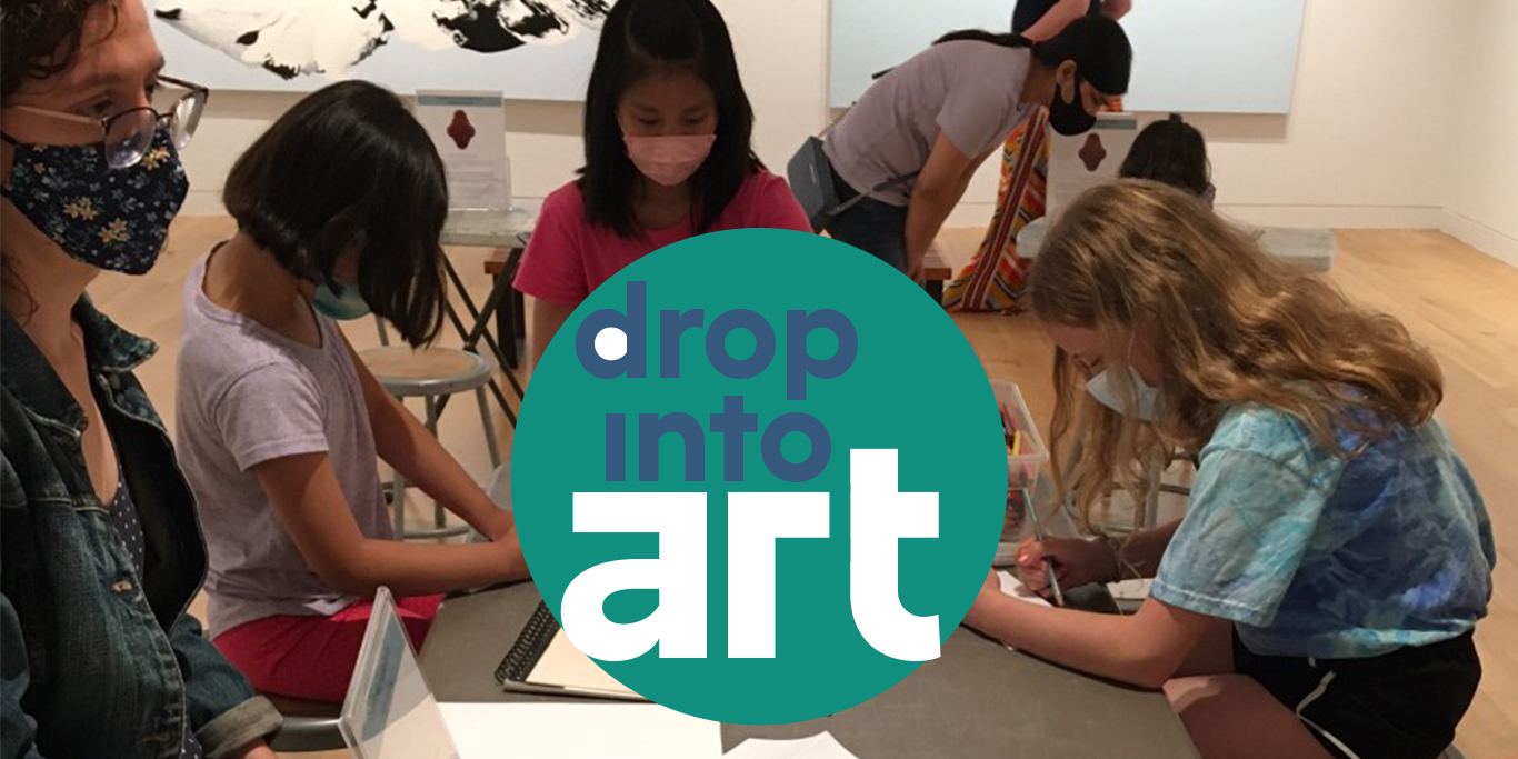 Photograph of a group of people around a table. Overlayed in the center is a teal circle with blue and white lettering reading 'drop into art'.