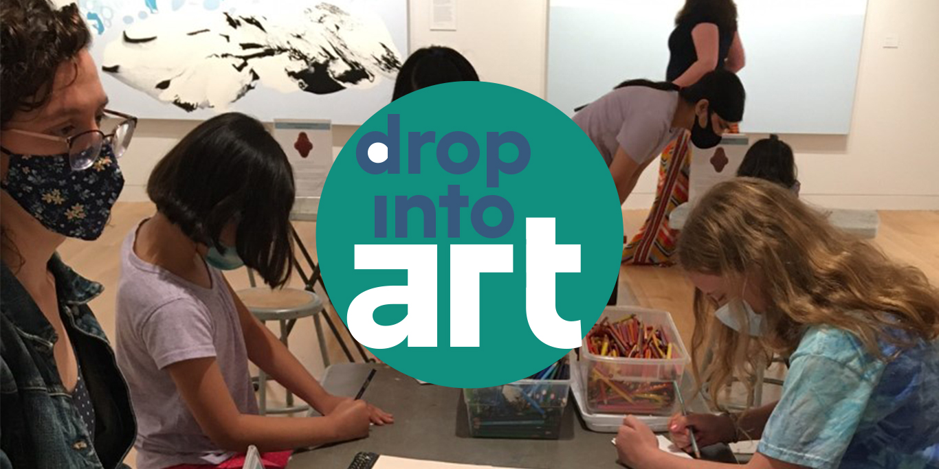 Photograph of a group of people around a table. Overlayed in the center is a teal circle with blue and white lettering reading 'drop into art'.