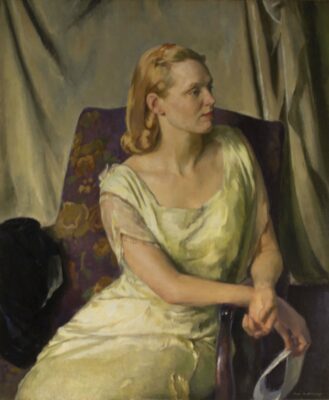 Portrait panting of a light skinned woman, seated, facing to the right, wearing a plain yellow dress with decorated sleeves. Her hair his blond and curled under and she is holding a paper in her hands.