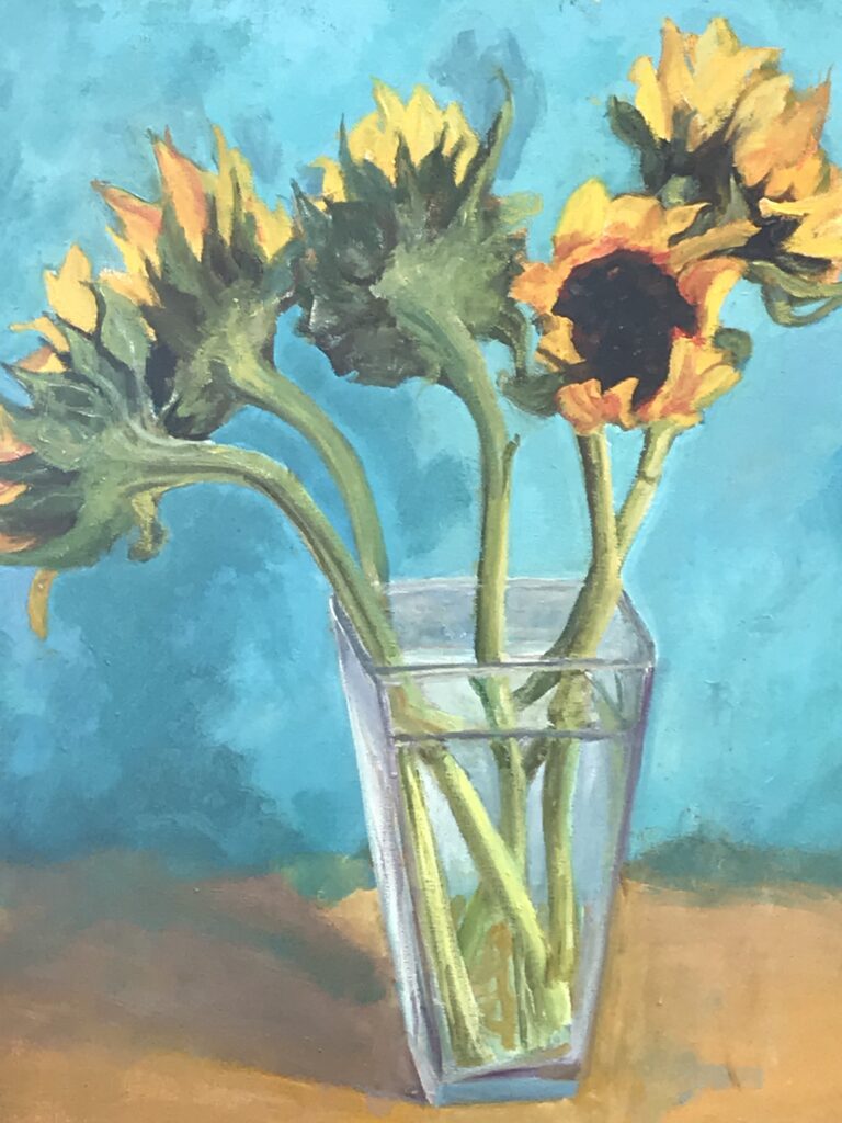 Painting of a glass vase filled with sunflowers on a brown table top and bright blue background.