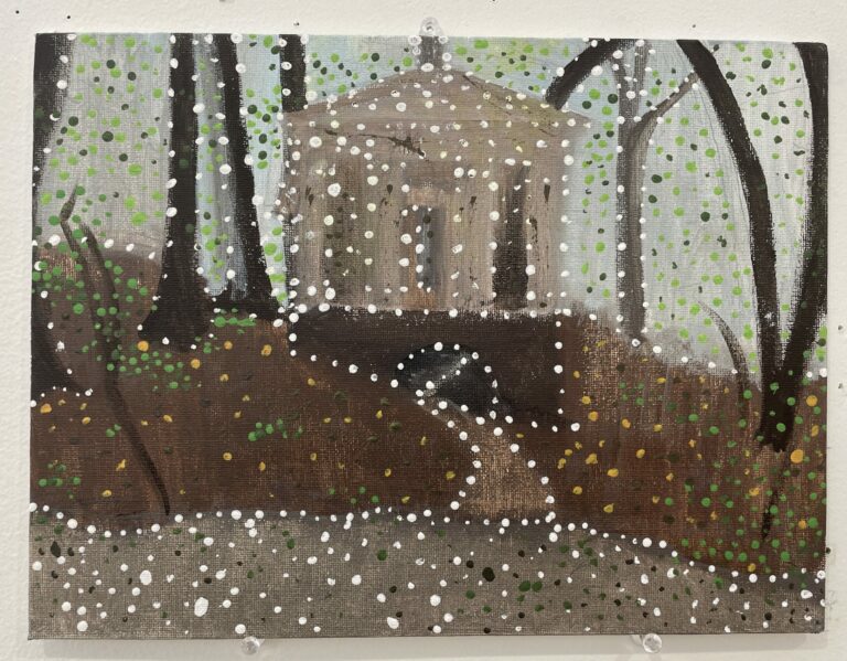 Photograph of an abstract landscape painting with leafless trees surrounding a tan building. Brown ground and a lighter brown path are around the building. There are dots of colors ranging from white, black, and green across the surface.