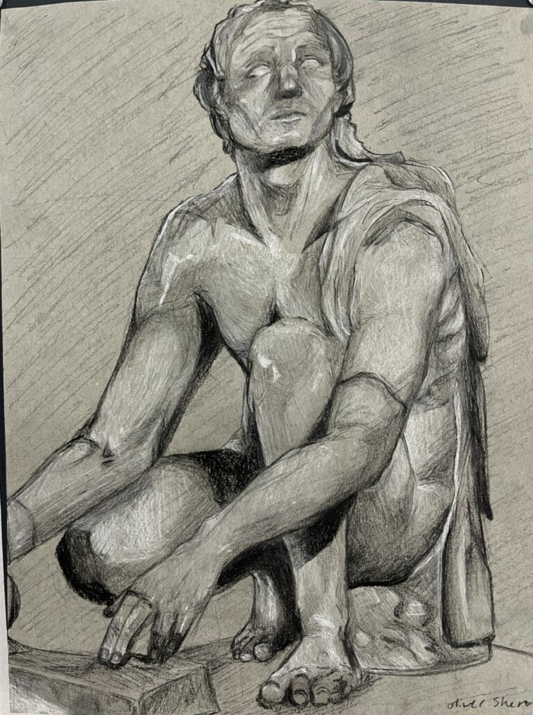 Photograph of a charcoal sketch figure on grey paper. The figure is crouched, facing left while looking outwards and up, wearing a draped piece of fabric over his right shoulder.