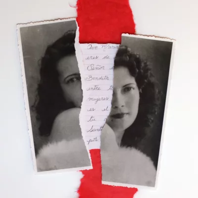 Photograph of an old black and white photo portrait of a woman ripped in half, each side now bracketing a red strip of vertical cloth and a written letter in Portuguese.