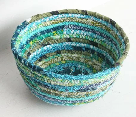 Photograph of a woven basket in shades of blues.