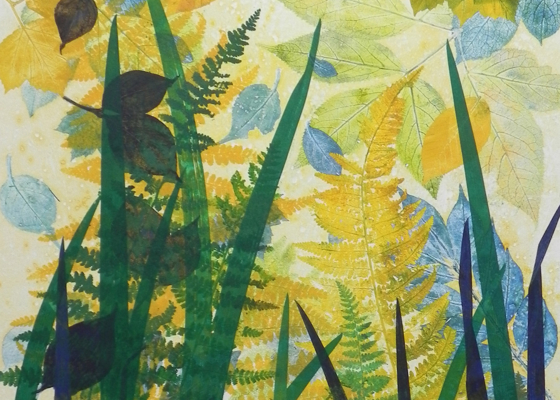Print with a cream background. Across the top are leaves printed in yellows, greens, and blues. At the bottom are deep green stems and grasses.