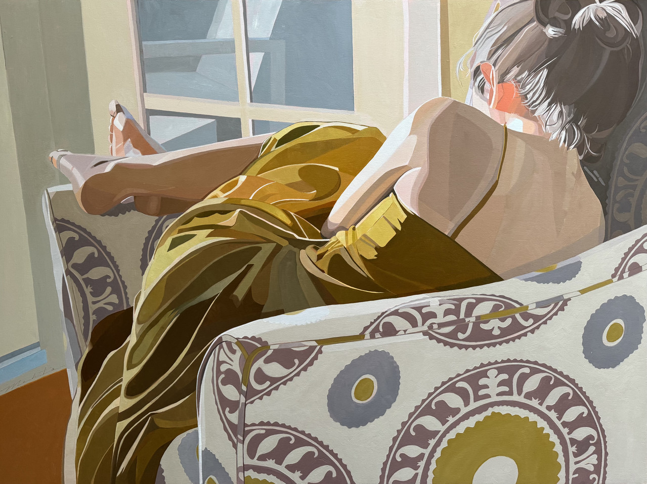 Painting of a woman curled up in a cream chair. She is wearing a gold long dress with thin straps, her hair is up in a bun, legs crossed over the far arm of the chair.