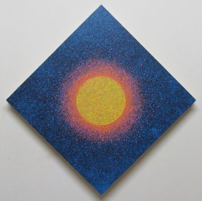 Diamond painting with a black and blue speckled background and a bright yellow orb in the center, surrounded by a speckled orange radiating band.