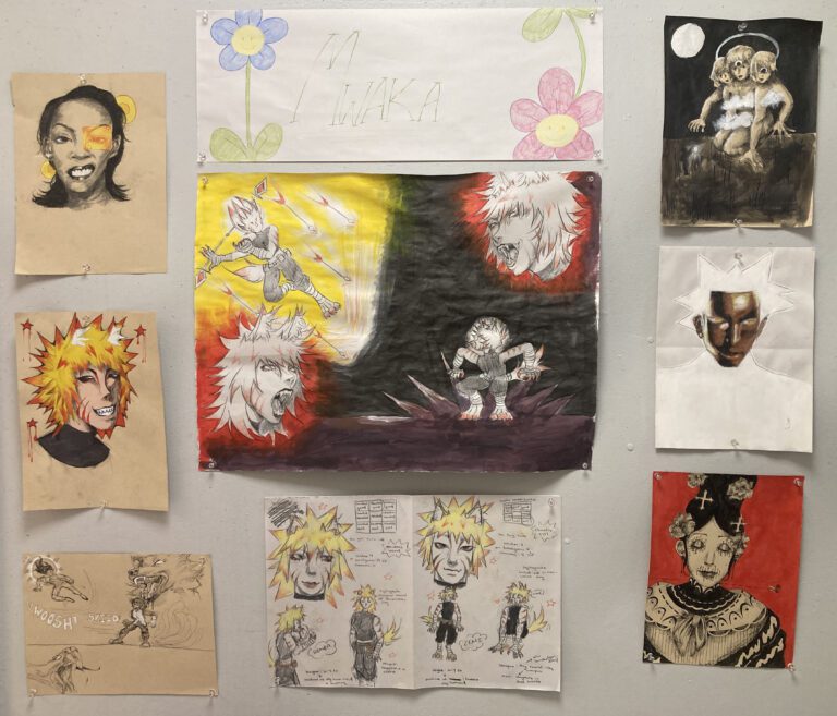 Photograph of multiple drawings pinned on a wall dealing with anime characters