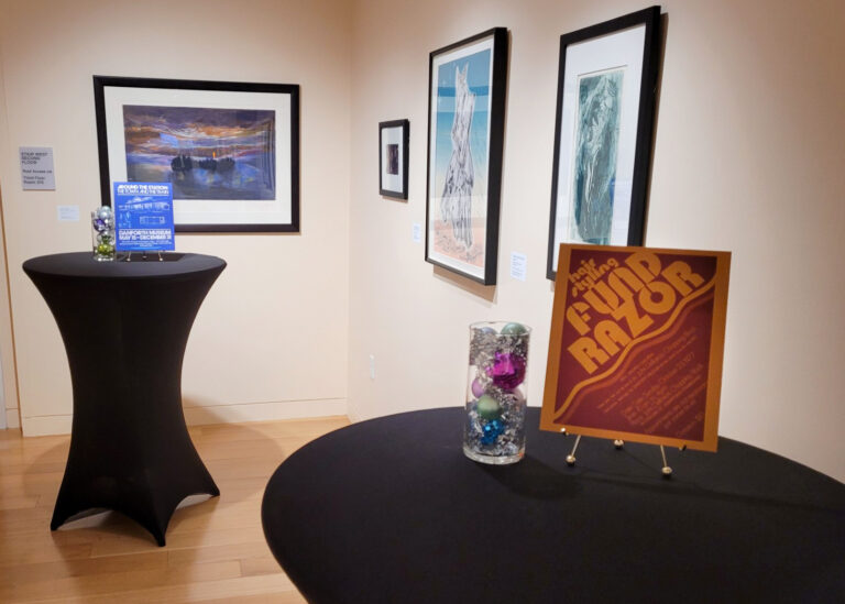 Photograph of high tops decorated for an event in a gallery.